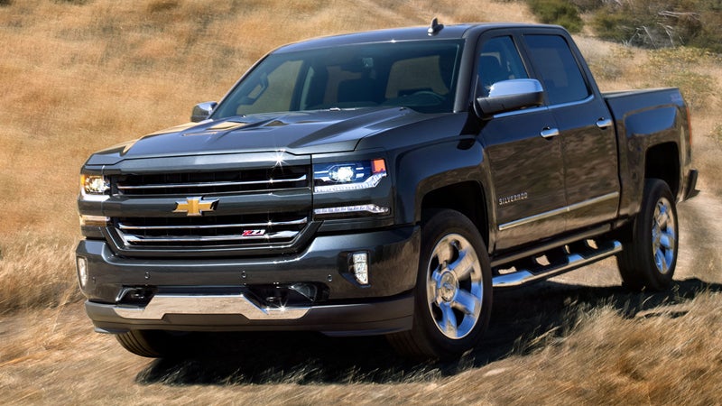 A Chevrolet Silverado 1500 driving through a grassy mountain